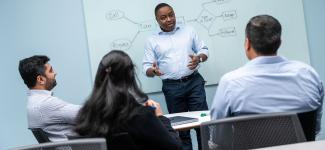 People working together around a whiteboard.